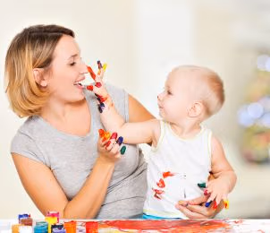 preview happy child draws face her nanny